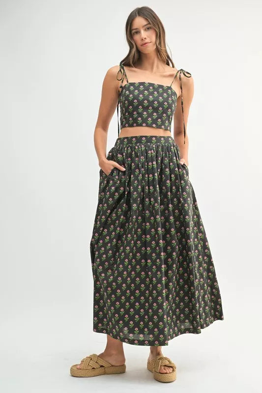 Woman wearing a LuxeHaven floral crop top and matching skirt set featuring feminine summer styling and a coordinated two-piece design
