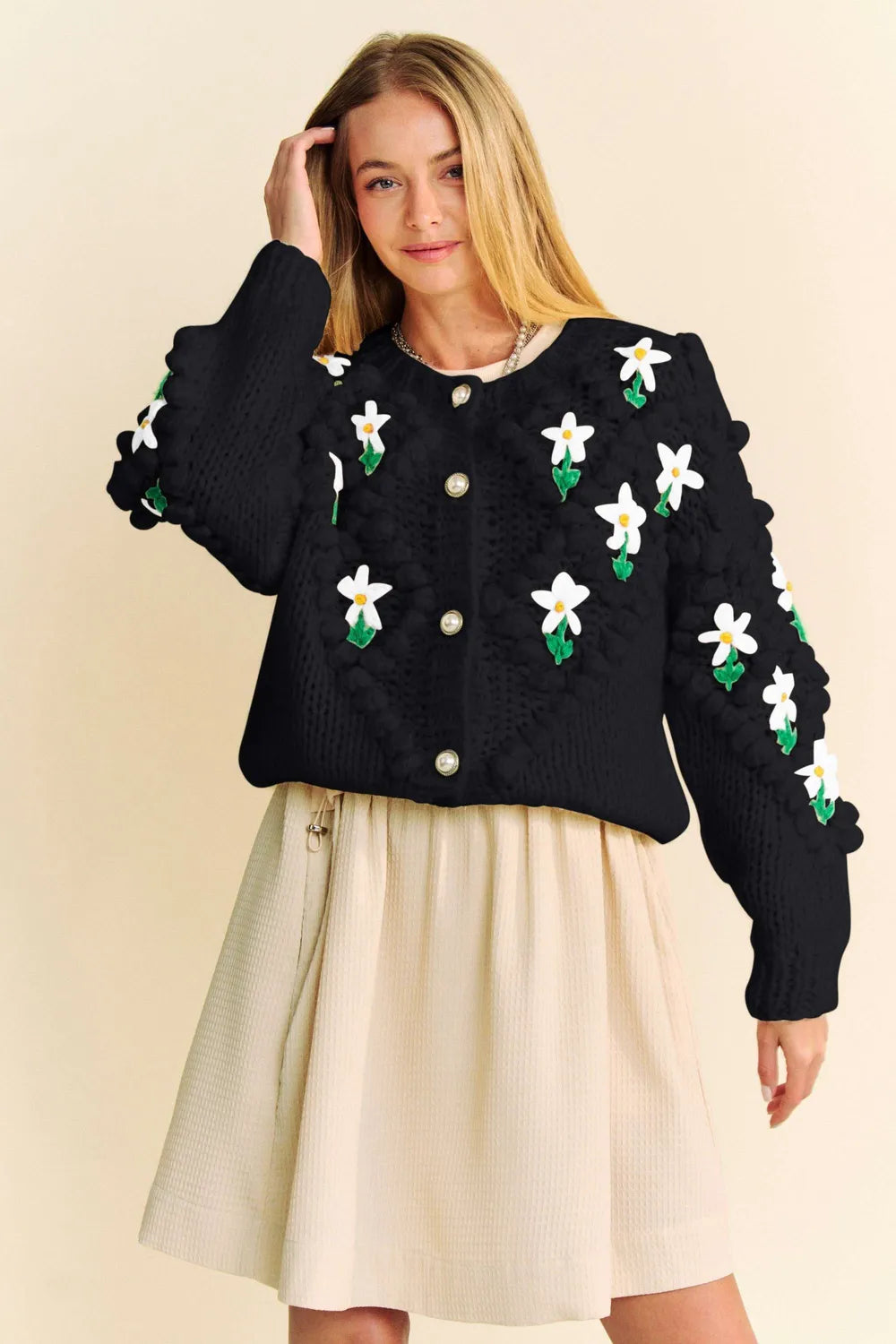Woman wearing a floral pattern button down cardigan sweater with a cozy knit design