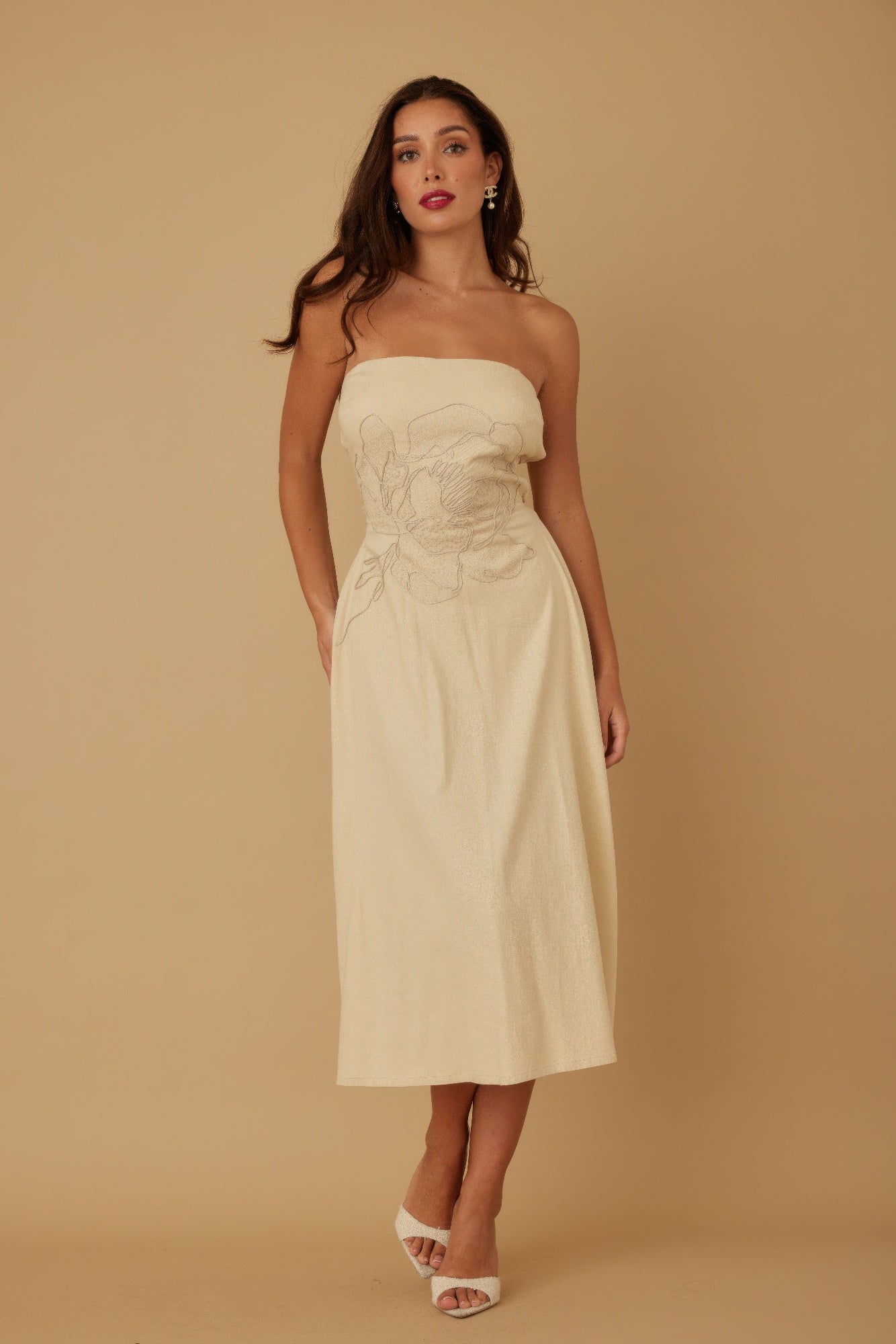 Woman wearing LuxeHaven flower lining linen pattern strapless dress with fitted bodice and flowing summer silhouette