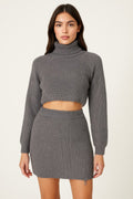 Woman wearing a LuxeHaven knit mock neck top and skirt set featuring a coordinated two-piece design and elegant knit styling