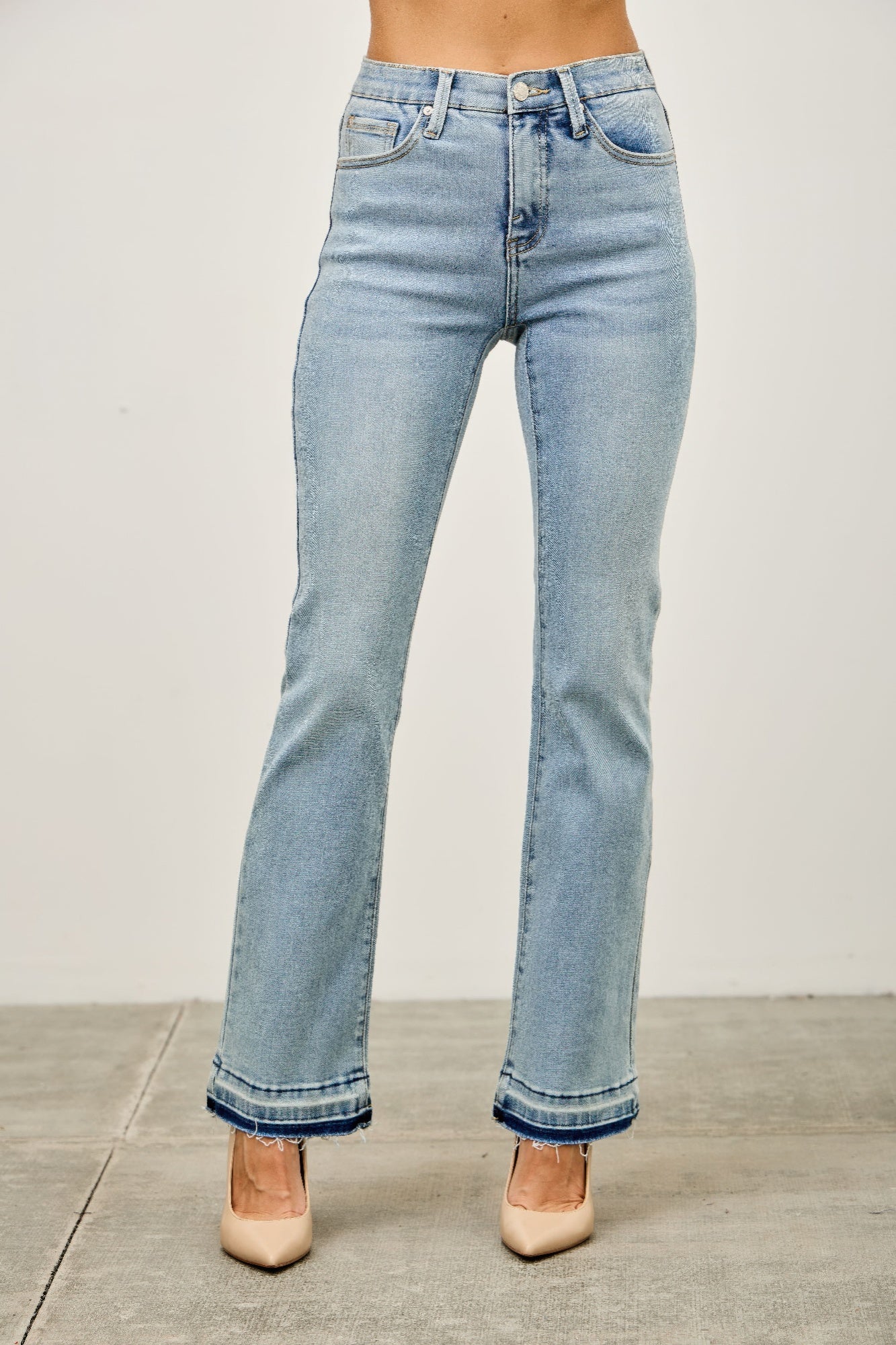 LuxeHaven™ mid-rise flare jeans with released raw hem, stretch denim fabric, and classic five-pocket styling.