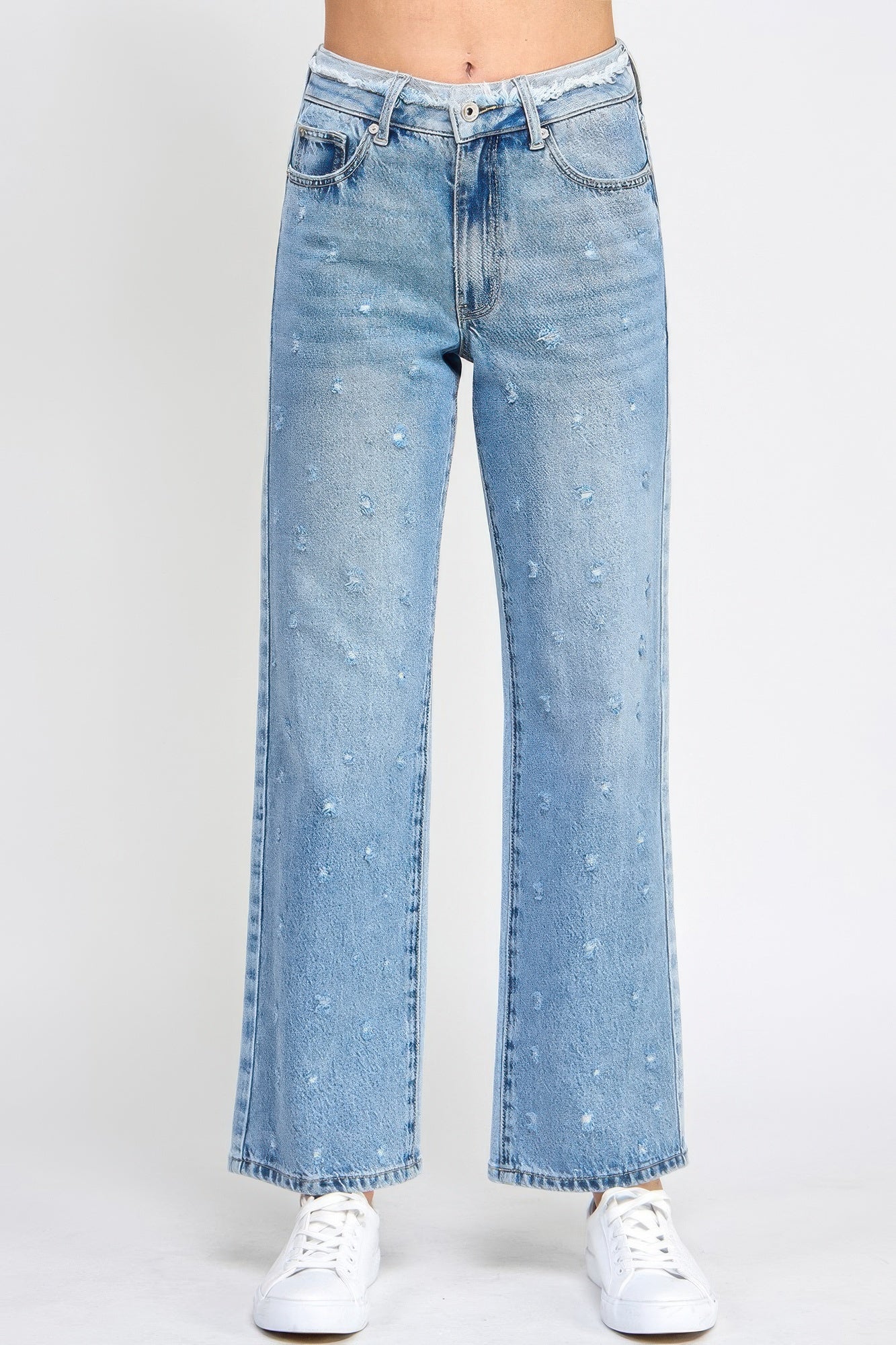 High rise dad jeans with fringe waistband detail, relaxed fit silhouette, and stretch denim fabric