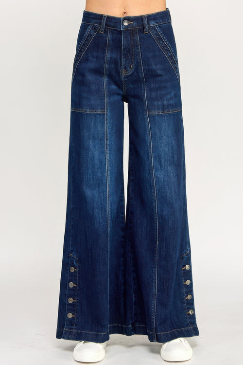 Woman wearing LuxeHaven™ high rise wide leg jeans with button slit detail on a white background.