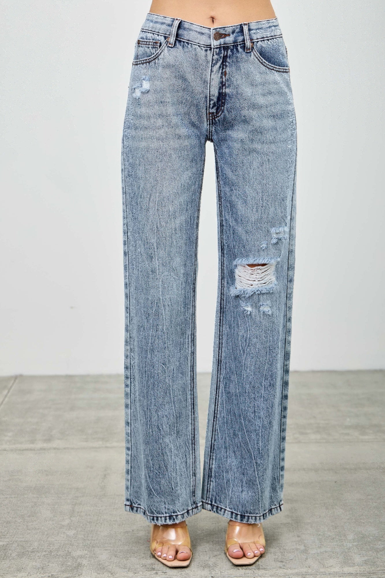 Women’s mid-rise relaxed straight-leg jeans with distressed detailing and vintage-inspired denim styling.