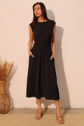 Women’s matte crepe midi dress with ruched elastic waist, elegant silhouette, and functional pockets.