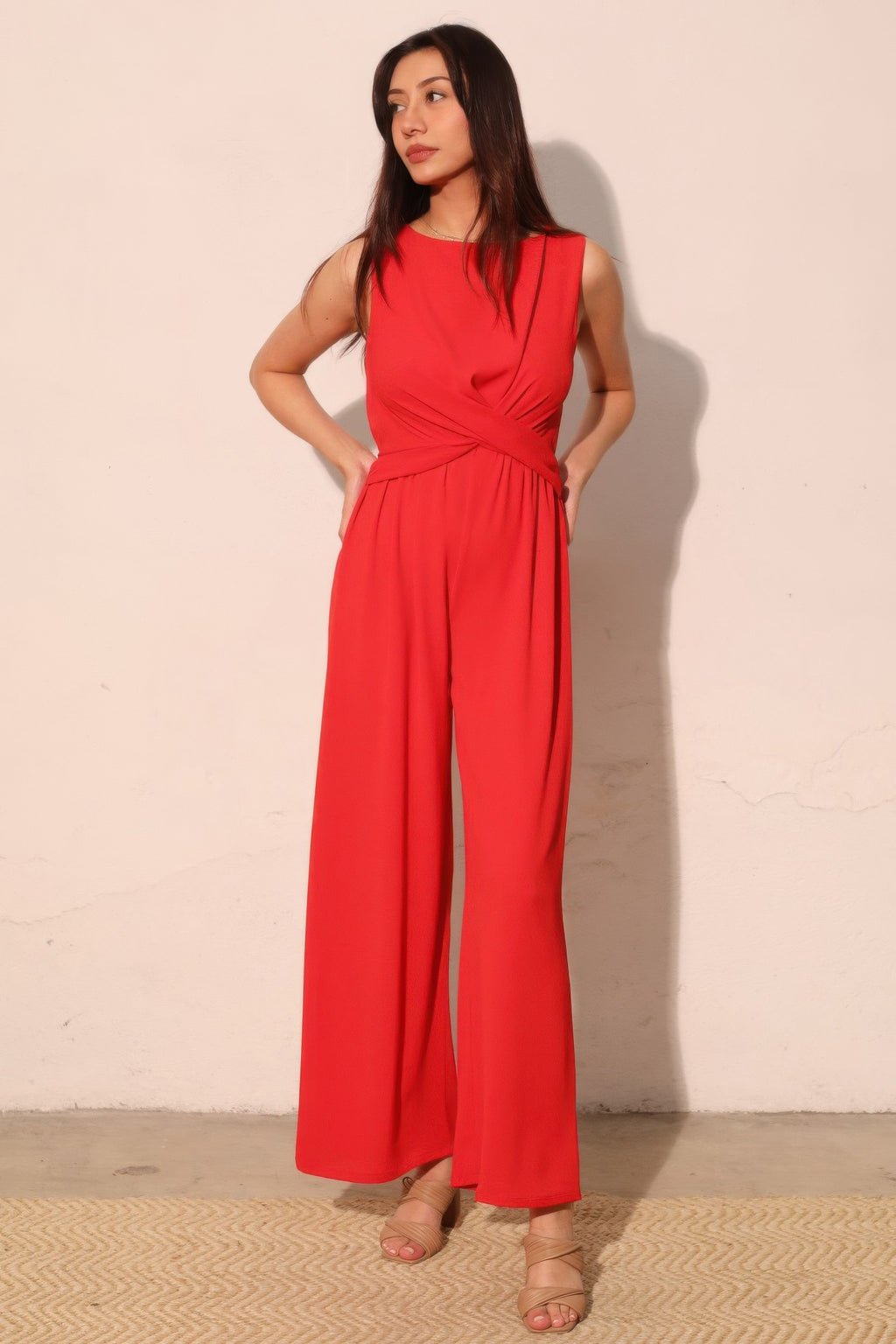 Textured twist front jumpsuit with wide leg silhouette and soft stretch fabric