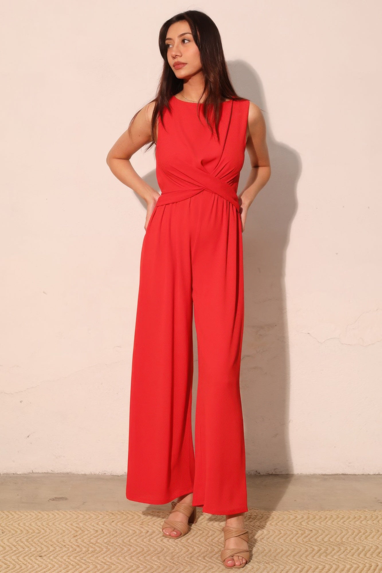 Textured twist front jumpsuit with wide leg silhouette and soft stretch fabric