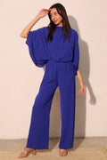 LuxeHaven™ Textured Solid Mock Neck Caftan Jumpsuit for women featuring a relaxed fit, textured fabric, mock neckline, and flowing wide leg silhouette