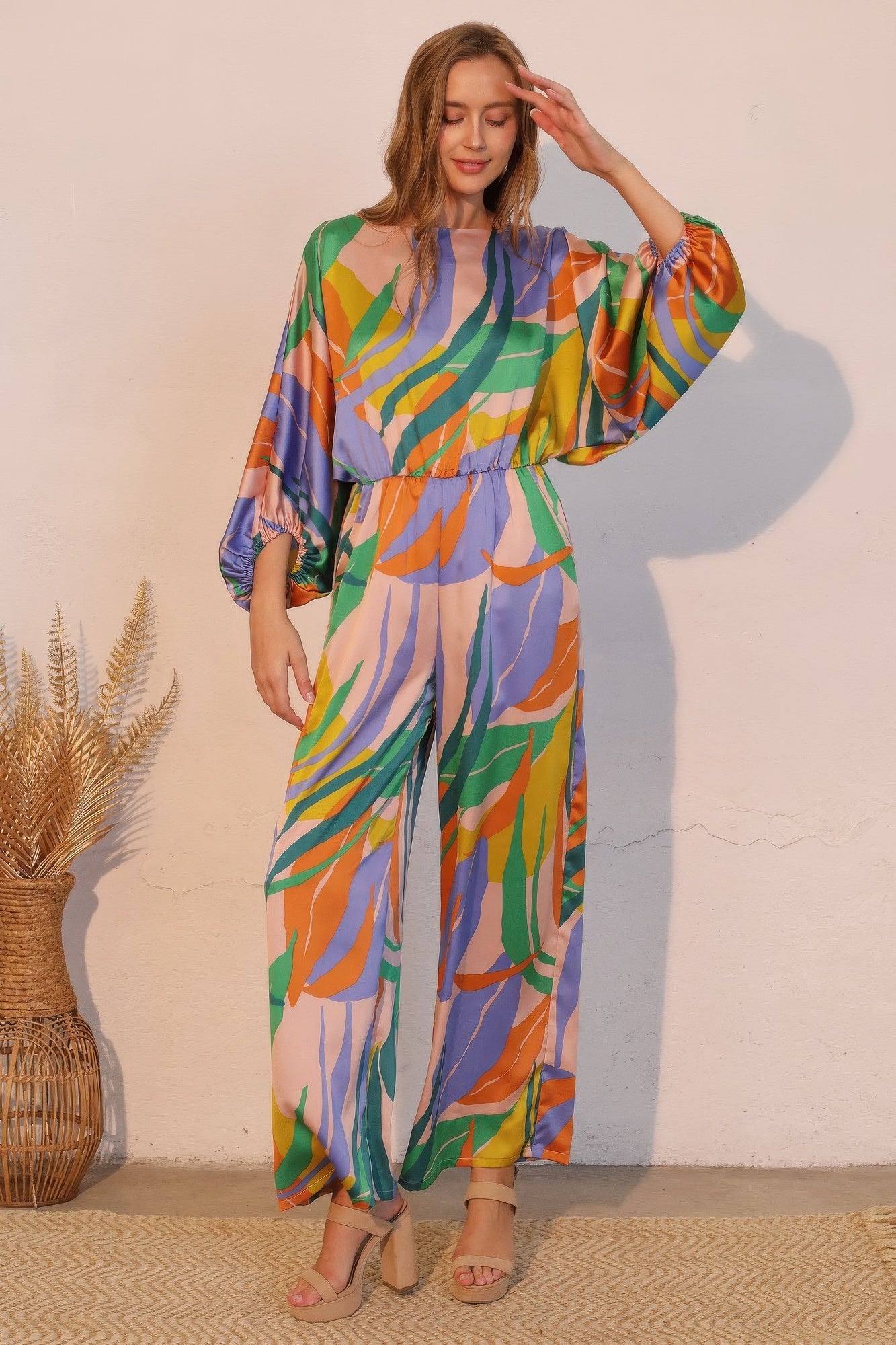 LuxeHaven™ women’s satin jumpsuit featuring Isla Tropical print, boat neckline, and blouson silhouette with flowy wide-leg pants for an elegant statement look.