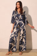 LuxeHaven Dreaming Lily Satin Cape Jumpsuit featuring smooth satin fabric, flowing cape detail, and elegant one-piece silhouette for sophisticated statement wear