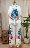 LuxeHaven™ women’s tropical two-piece set featuring palm print button-up top, wide-leg pants, and lightweight flowy fabric for effortless vacation styling.