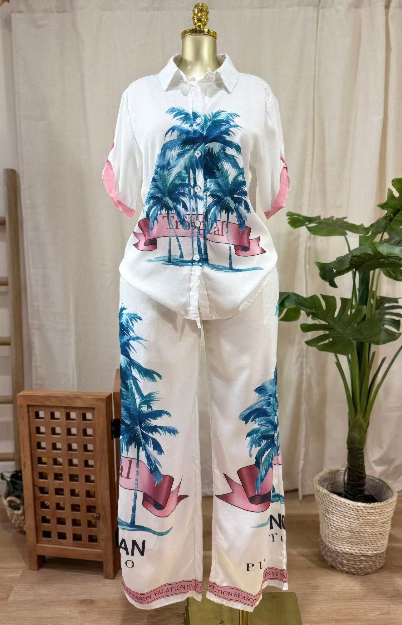 LuxeHaven™ women’s tropical two-piece set featuring palm print button-up top, wide-leg pants, and lightweight flowy fabric for effortless vacation styling.