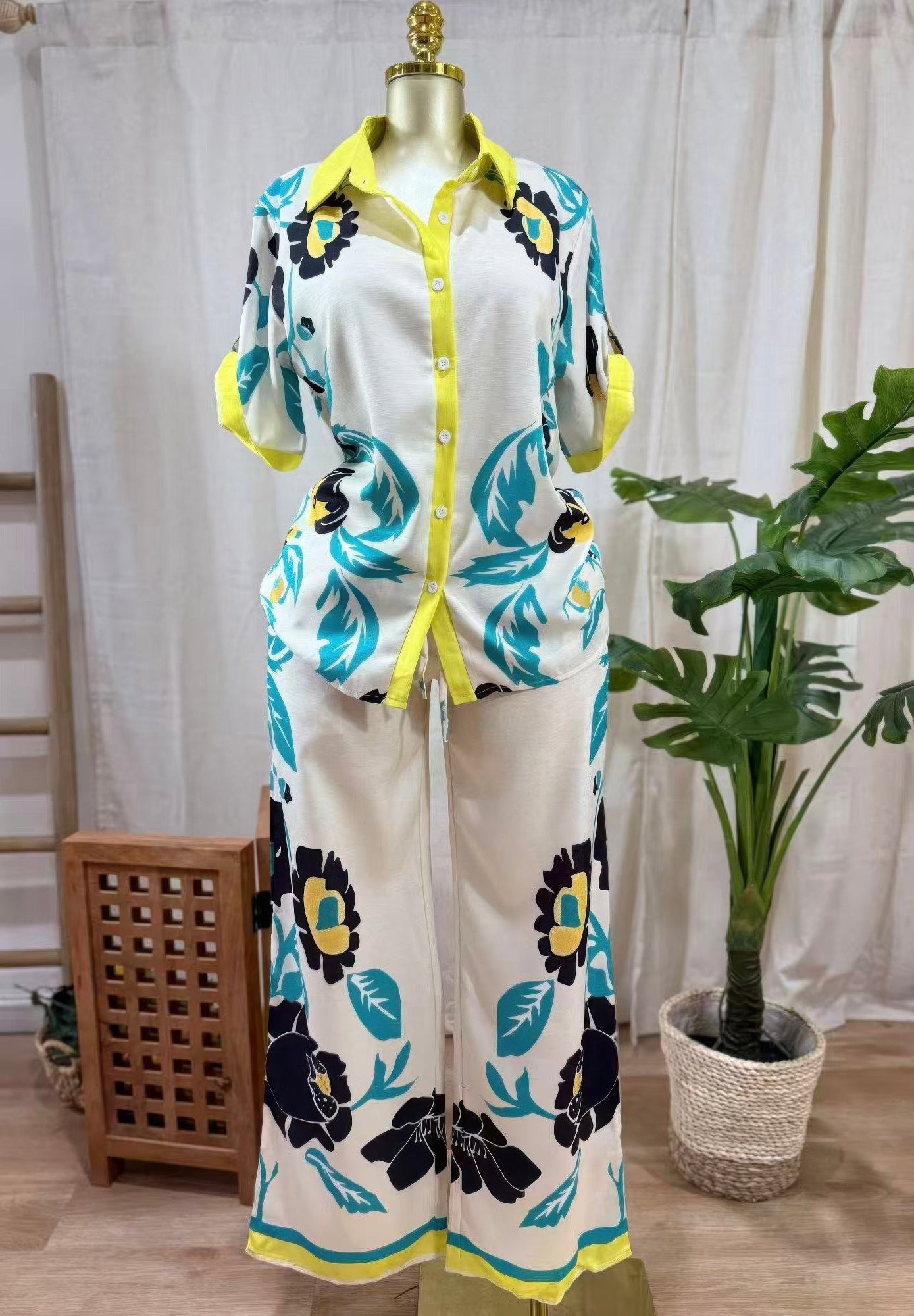 LuxeHaven™ women’s floral two-piece set featuring relaxed button-up top, wide-leg pants, and bold Lime Bloom print for effortless statement styling.