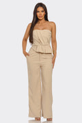 LuxeHaven™ women’s elegant two-piece set featuring strapless pleated peplum top and high-waisted wide-leg trousers for sophisticated statement styling.