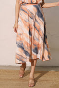 LuxeHaven™ women’s midi swing skirt featuring cloud tie-dye print in peach and grey tones, flowy A-line silhouette, and lightweight fabric for effortless styling.