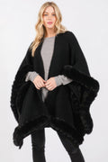 Woman wearing LuxeHaven™ faux fur trim cape with elegant front closure