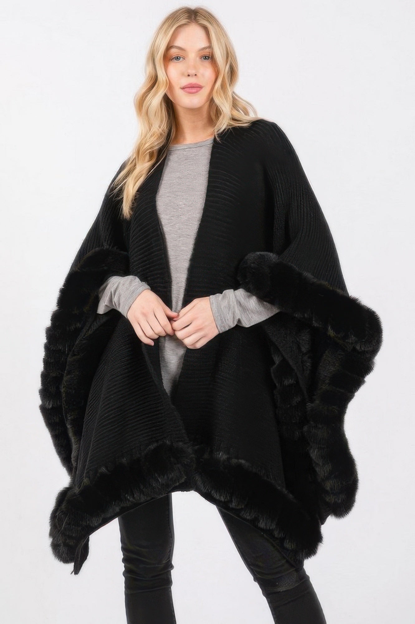 Woman wearing LuxeHaven™ faux fur trim cape with elegant front closure