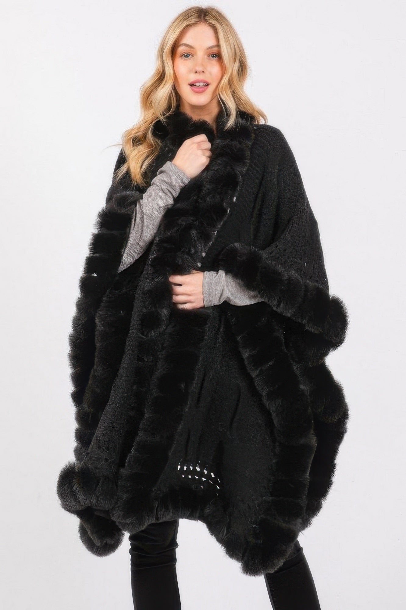Woman wearing LuxeHaven™ faux fur collar and trim cape with elegant front closure
