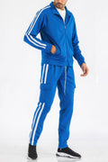 Man wearing a LuxeHaven two stripe utility pocket track suit featuring contrast side stripes, utility pockets, and a coordinated athletic design