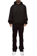 Man wearing LuxeHaven solid stacked flared track set with matching track jacket and flared track pants.