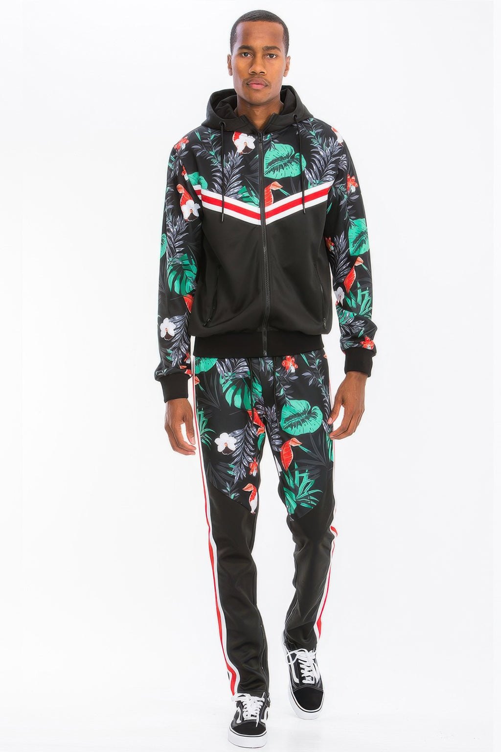 Man wearing a LuxeHaven printed polyester track set featuring a tropical leaf print, zip-up hoodie, and matching track pants